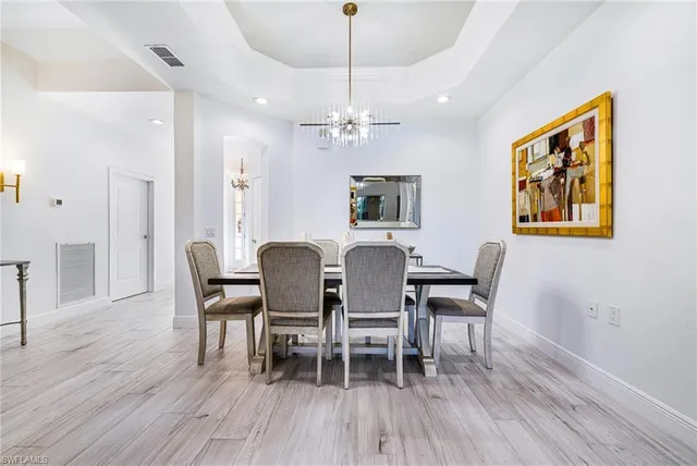 a view of a dining room with furniture wooden floor and a chandelier