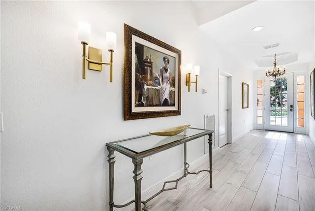 a view of a hallway with furniture and front door