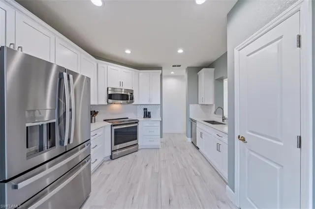 a kitchen with stainless steel appliances a refrigerator stove and oven