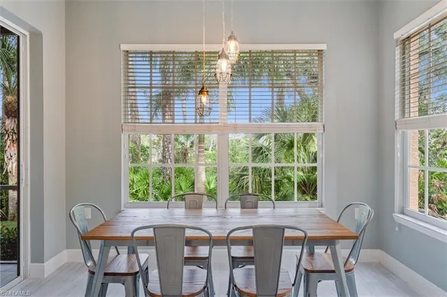 a dining room with furniture a chandelier and wooden floor