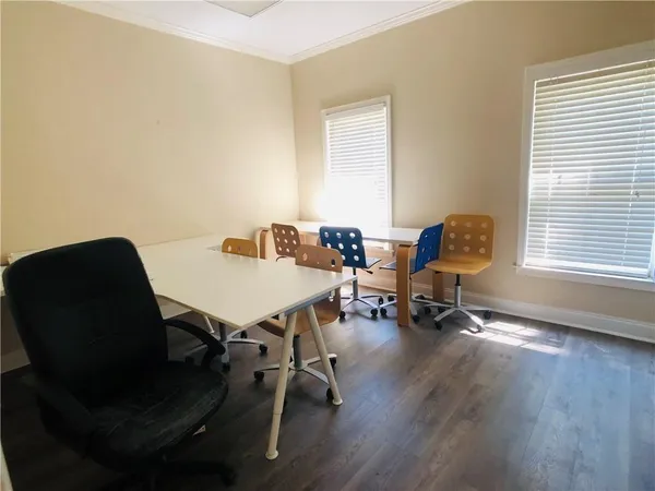 a view of a workspace with furniture and a window