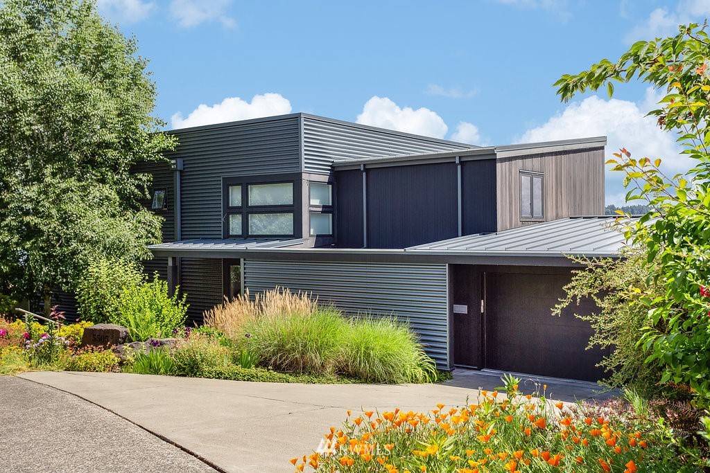 5505 South Upland Road Seattle, WA 98118 - Photo 2 of 32 a front view of a house with a garden