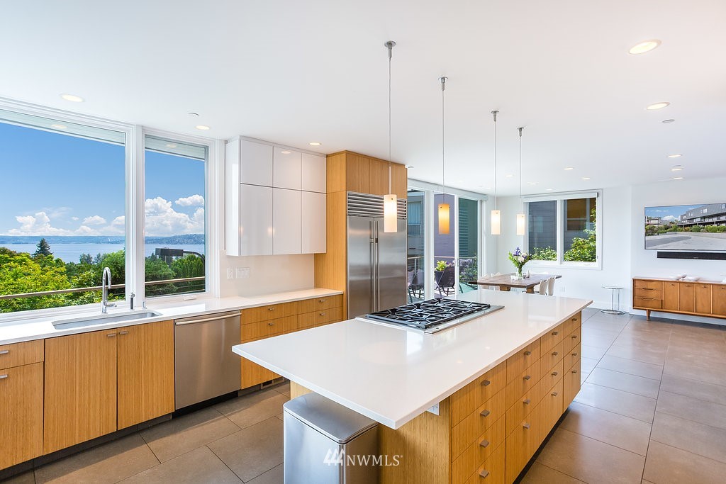 5505 South Upland Road Seattle, WA 98118 - Photo 11 of 32 a kitchen with a stove a sink a counter top space and living room view