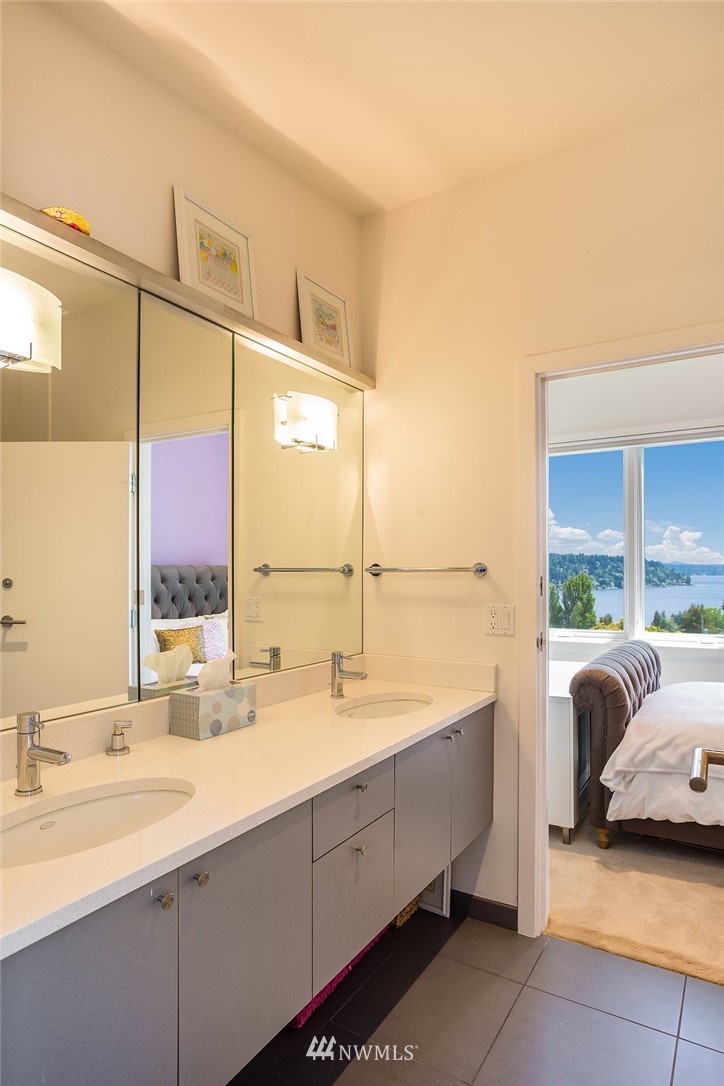 5505 South Upland Road Seattle, WA 98118 - Photo 18 of 32 a bathroom with a double vanity sink and mirror