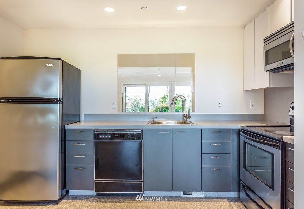 5505 South Upland Road Seattle, WA 98118 - Photo 24 of 32 a kitchen with a sink and a refrigerator