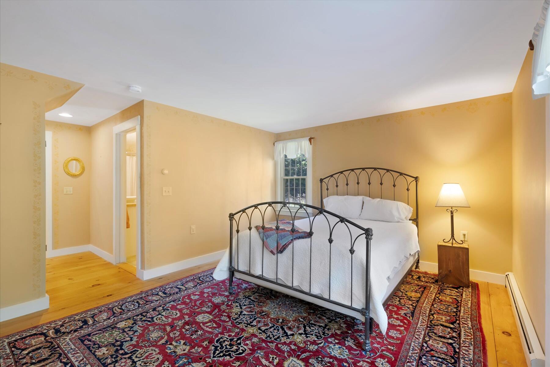 307 Bank Street Harwich, MA 02645 - Photo 22 of 45 a bedroom with a bed and wooden floor