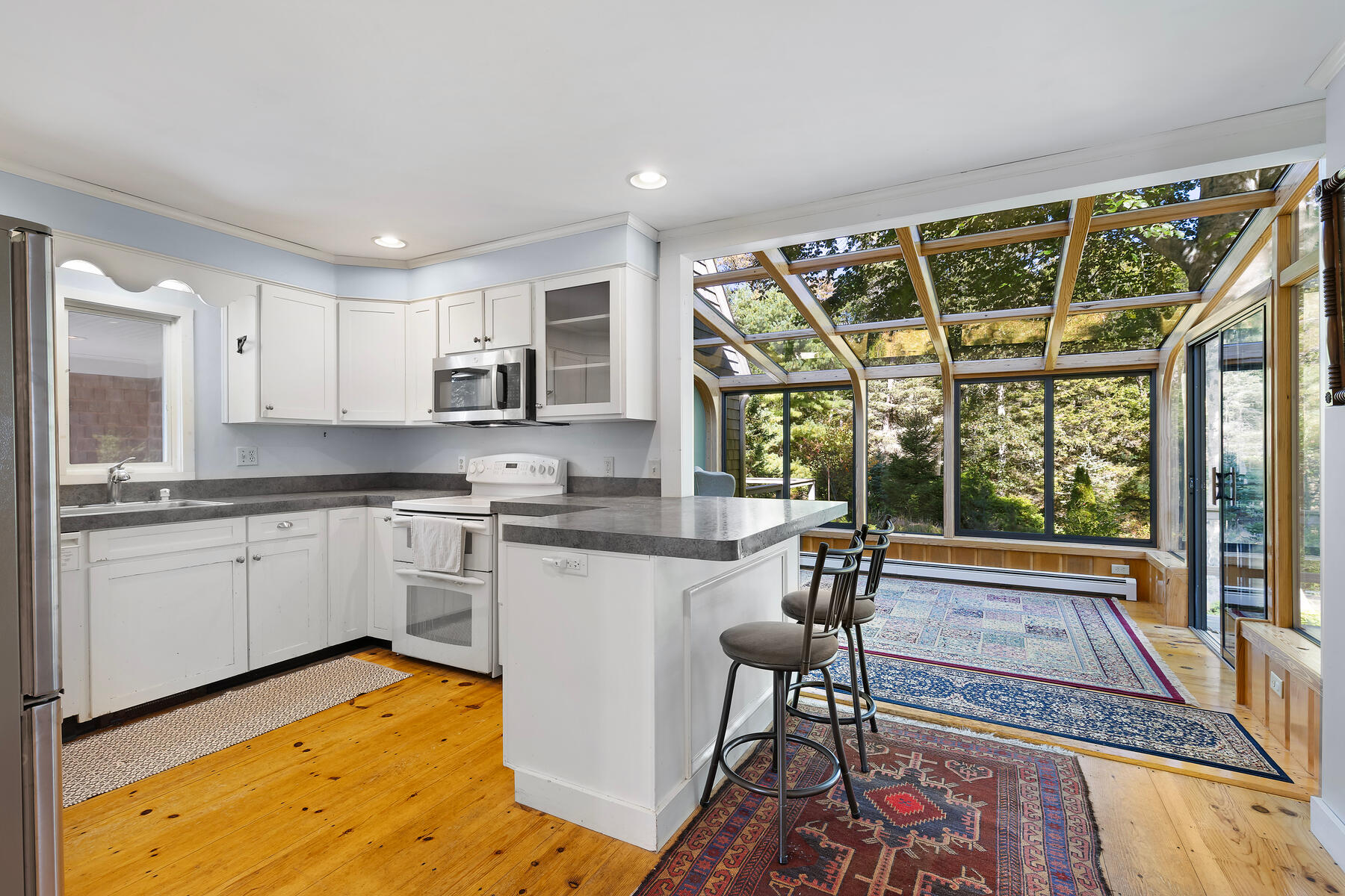 307 Bank Street Harwich, MA 02645 - Photo 9 of 45 a kitchen with a table chairs stove and cabinets