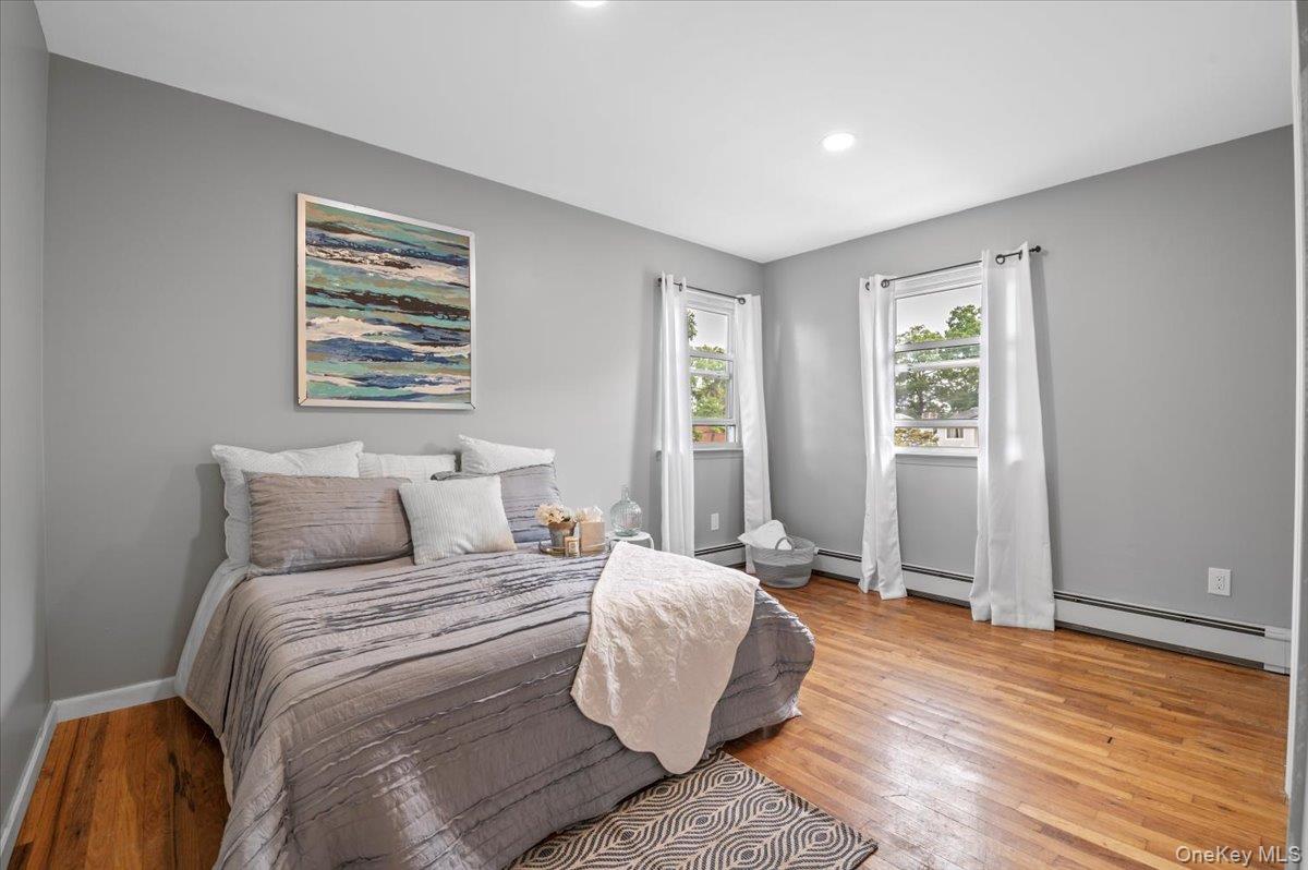 7 Bennett Court Copiague, NY 11726 - Photo 14 of 22 a bedroom with a large bed and a window