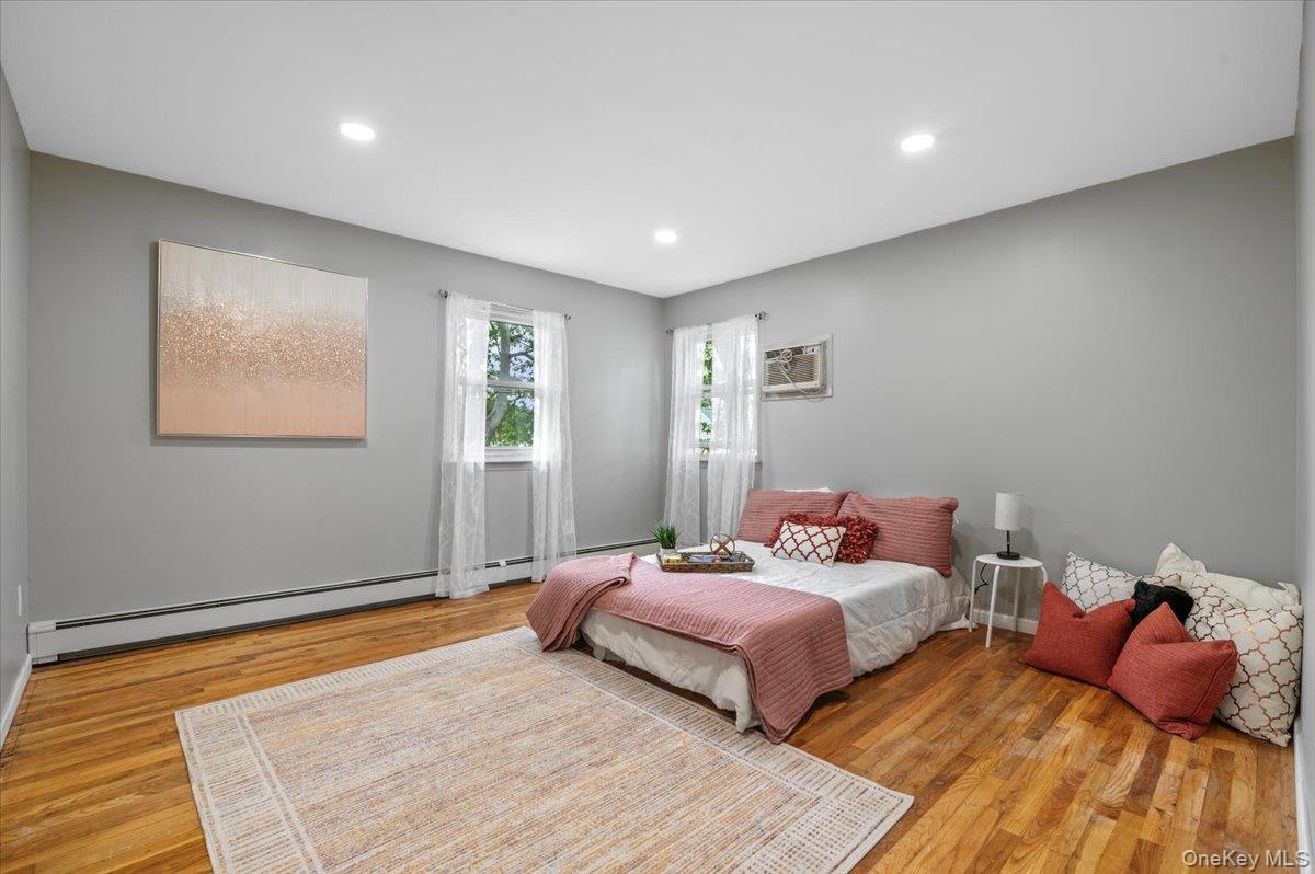 7 Bennett Court Copiague, NY 11726 - Photo 15 of 22 a bedroom with a bed and window