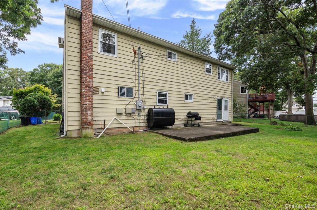 7 Bennett Court Copiague, NY 11726 - Photo 19 of 22 a view of a house with a backyard and chairs