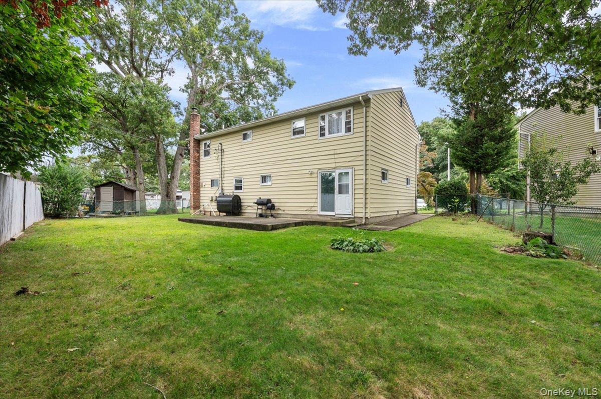 7 Bennett Court Copiague, NY 11726 - Photo 20 of 22 a view of a house with backyard and a tree