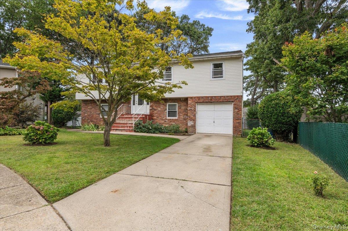 7 Bennett Court Copiague, NY 11726 - Photo 21 of 22 a front view of a house with a yard