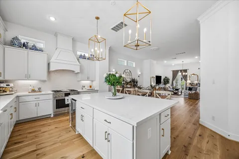 a kitchen with sink stove and cabinets