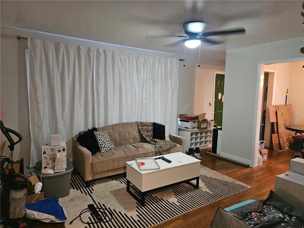 5341 Old Floyd Road Southwest Mableton, GA 30126 - Photo 2 of 8 a living room with furniture a lamp and a rug