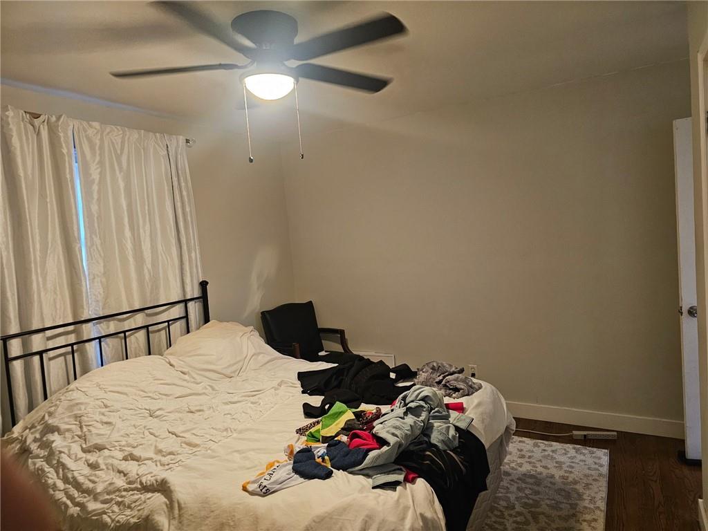 5341 Old Floyd Road Southwest Mableton, GA 30126 - Photo 6 of 8 a bedroom with a bed and a chandelier