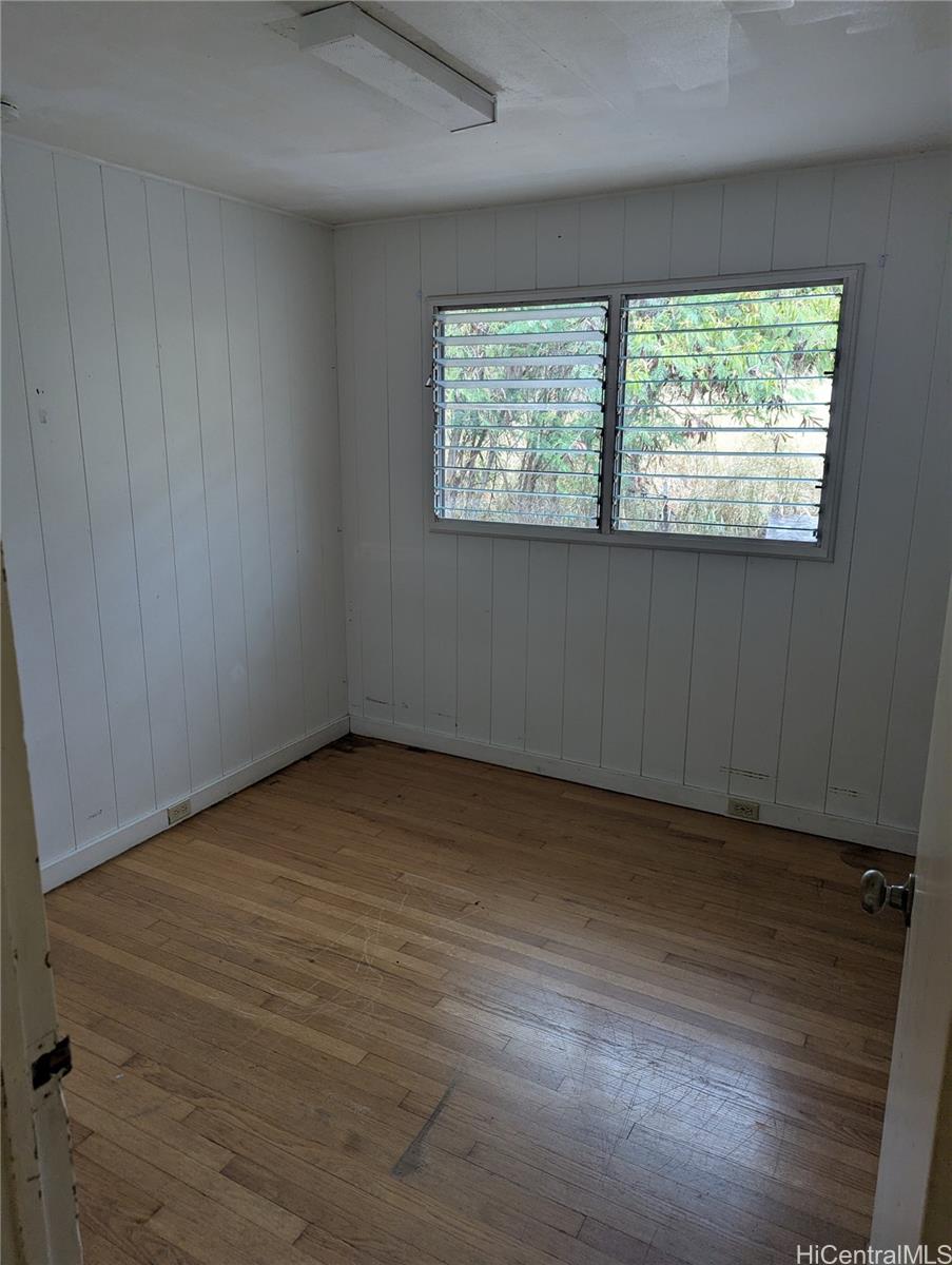 85-775A Waianae Valley Road Waianae, HI 96792 - Photo 13 of 25 an empty room with wooden floor and windows