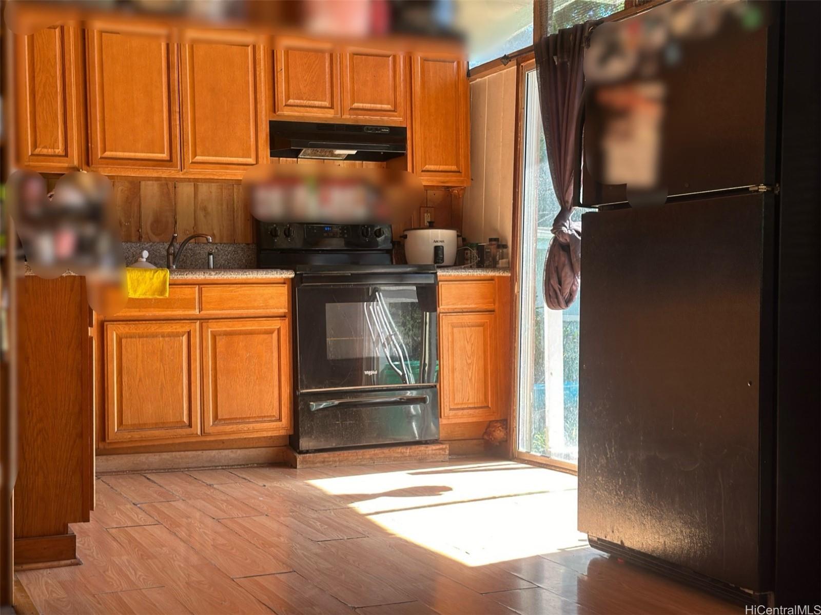 85-775A Waianae Valley Road Waianae, HI 96792 - Photo 4 of 25 a kitchen with a refrigerator and cabinets