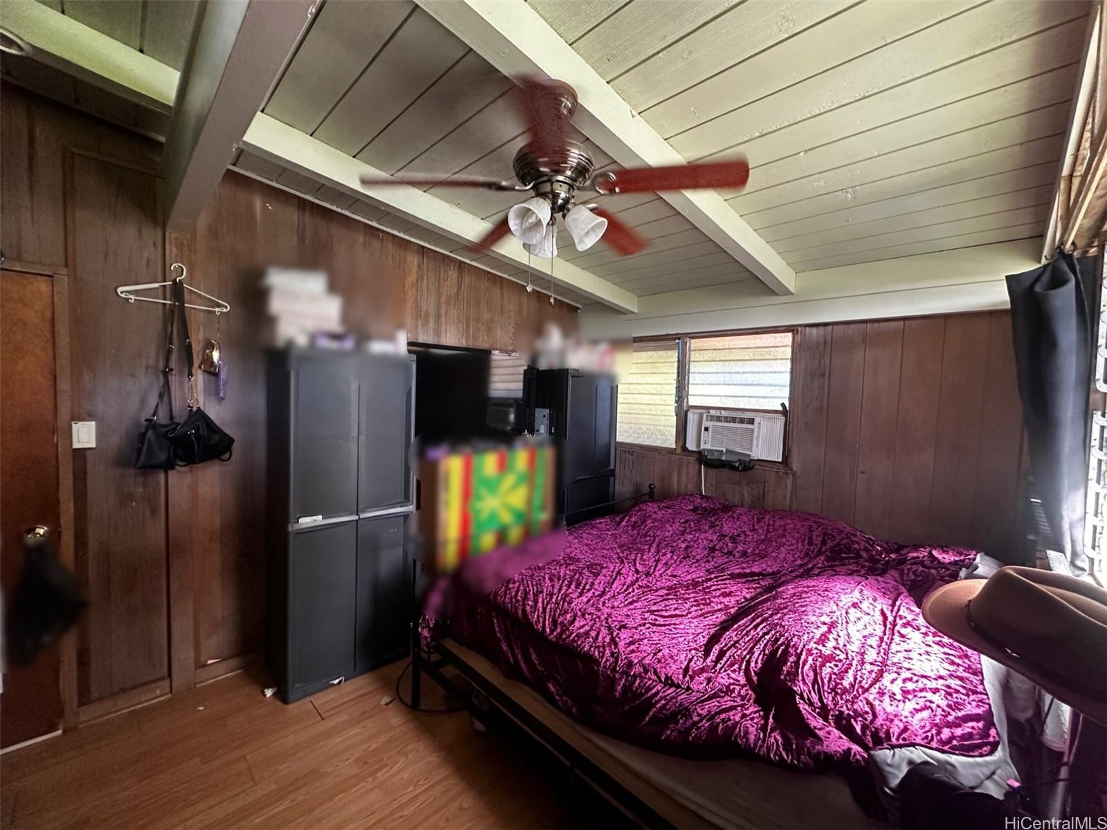 85-775A Waianae Valley Road Waianae, HI 96792 - Photo 7 of 25 a bedroom with a bed and a refrigerator
