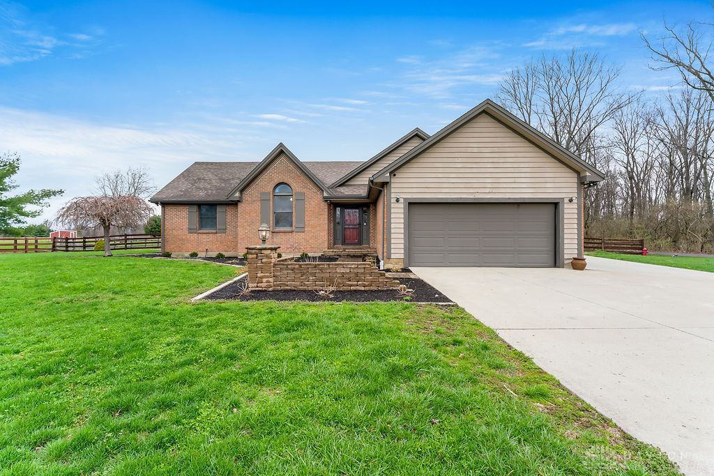 7400 Cook-Jones Road Waynesville, OH 45068 - Photo 69 of 72 This charming home features a brick and siding exterior, an attached garage, and a lush green lawn.