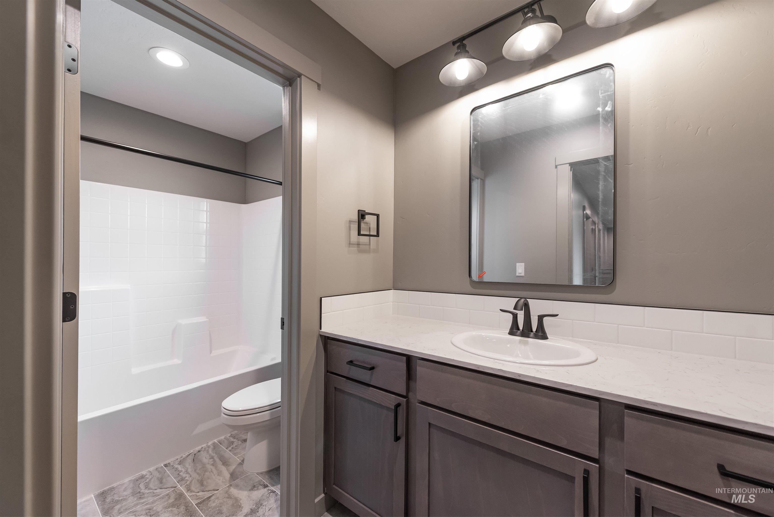 360 South Bumper Way Boise, ID 83716 - Photo 26 of 34 Full bathroom featuring vanity and tub / shower combination