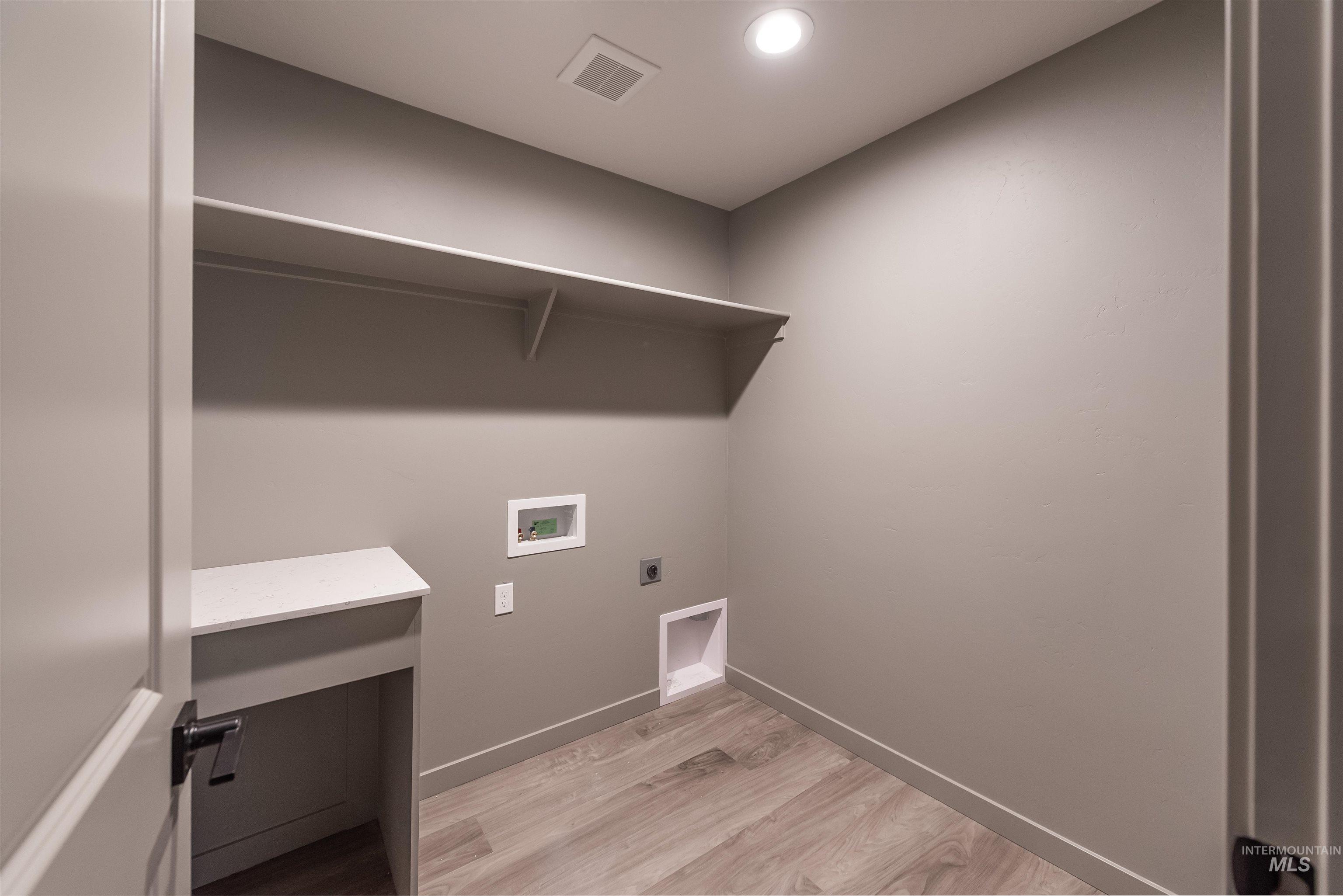 360 South Bumper Way Boise, ID 83716 - Photo 29 of 34 Laundry room featuring hookup for a washing machine, electric dryer hookup, light wood-type flooring, and recessed lighting