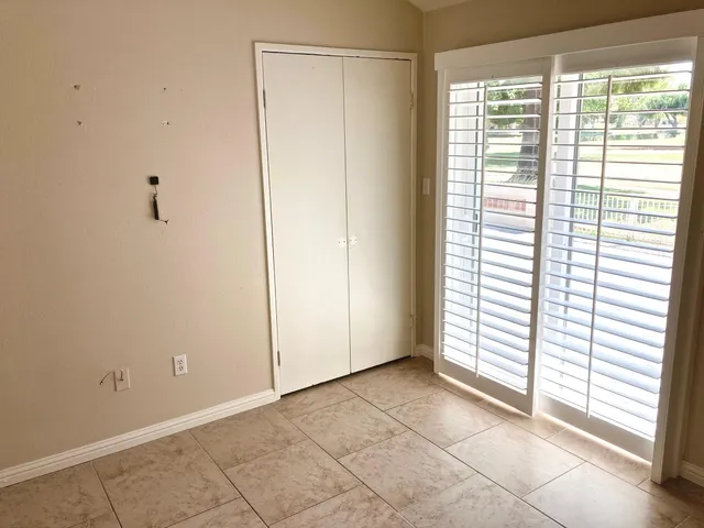 a view of a park with swings and a fence