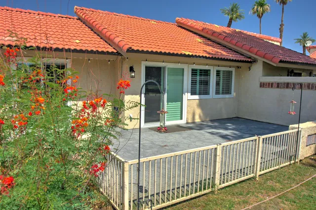 a front view of a building with a garden