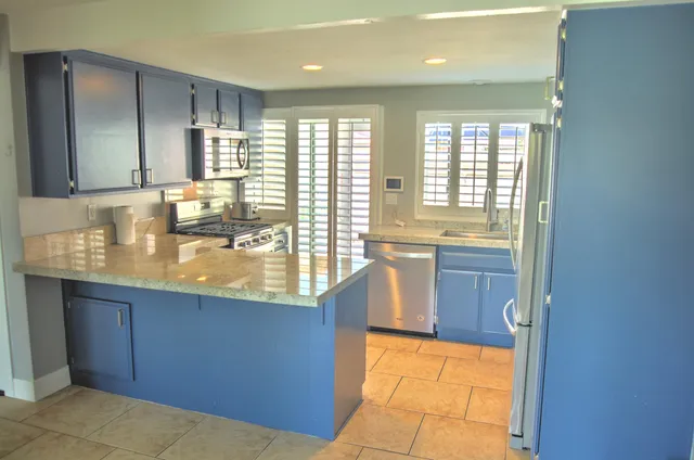 a bathroom with a sink a bathtub and next to a window