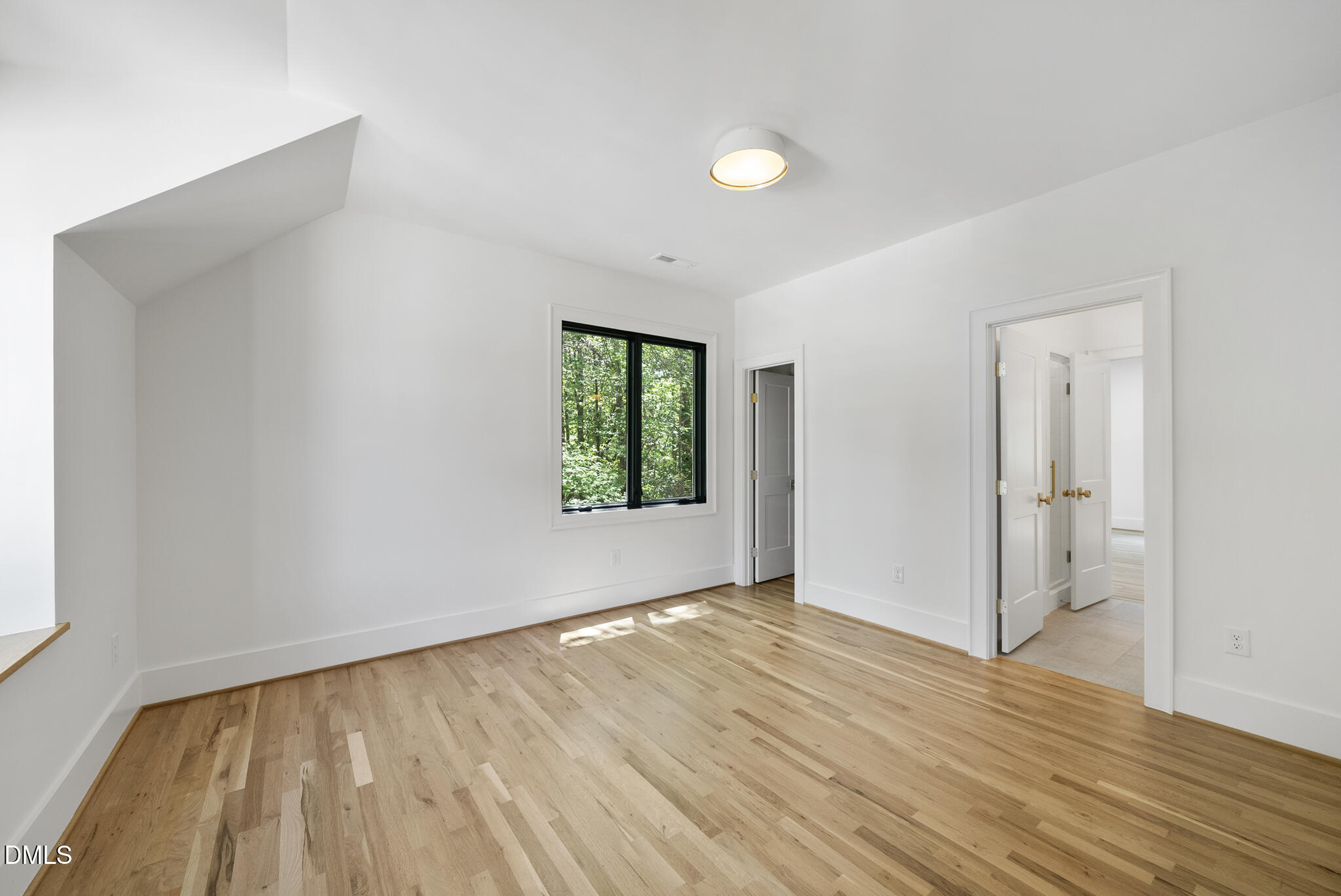 1609 Ridge Road Raleigh, NC 27607 - Photo 35 of 62 a view of an empty room with wooden floor and a window