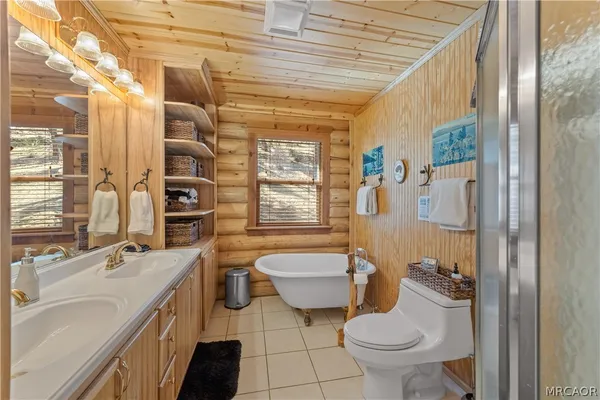 a bathroom with a granite countertop toilet a sink and a bathtub