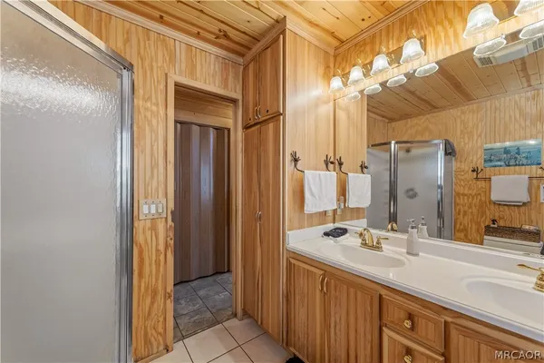 a bathroom with a double vanity sink and a mirror