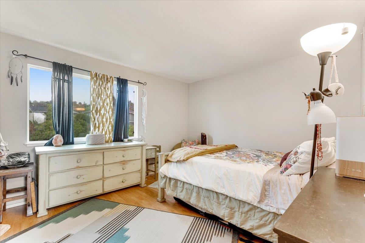 7245 Lotus Way Aptos, CA 95003 - Photo 13 of 20 a bedroom with a bed and a chandelier