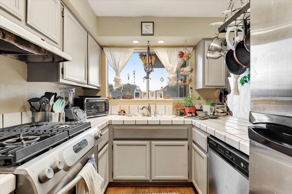 7245 Lotus Way Aptos, CA 95003 - Photo 4 of 20 a kitchen with a stove a sink and a microwave