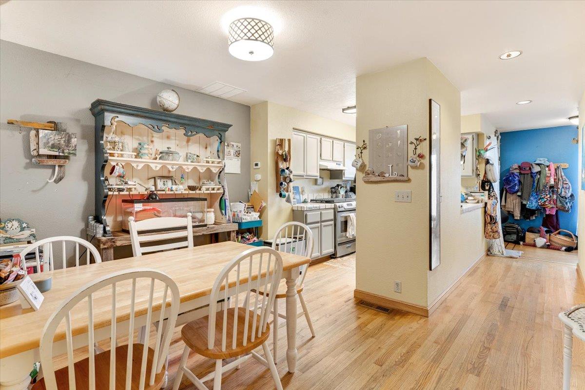 7245 Lotus Way Aptos, CA 95003 - Photo 6 of 20 a view of a dining room with furniture a chandelier and wooden floor