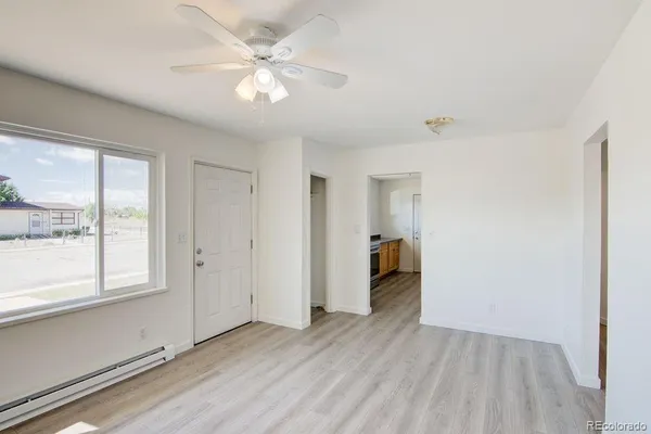 wooden floor in an empty room with a window