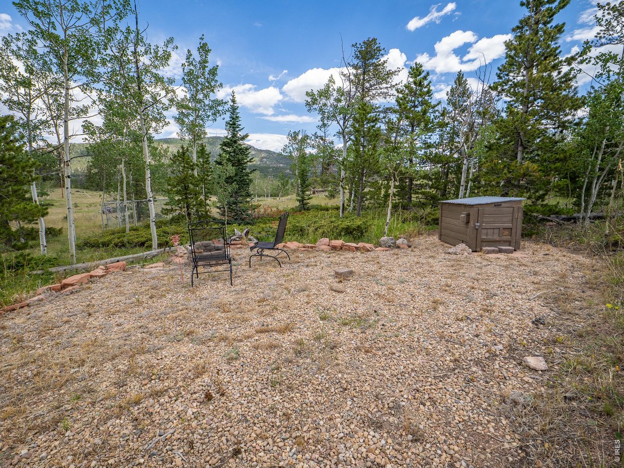 22 Tami Road Red Feather Lakes, CO 80545 - Photo 7 of 33 Graveled campsite in the trees.