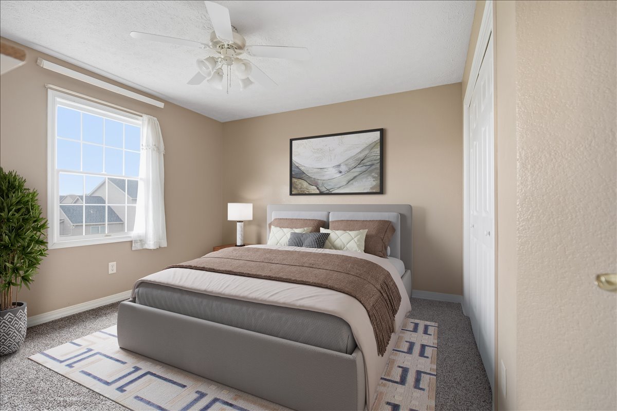 3255 Fire Fly Court Normal, IL 61761 - Photo 15 of 25 a bedroom with a bed and a chandelier