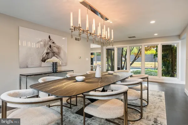 a kitchen with stainless steel appliances granite countertop a sink and white cabinets with wooden floor
