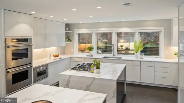 a dining room with furniture a chandelier and glass door