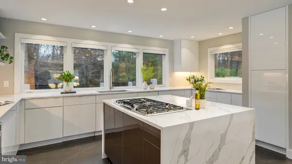 a spacious bedroom with a bed and a large window