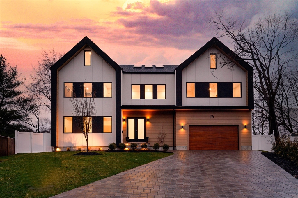 a front view of a house with a yard and garage