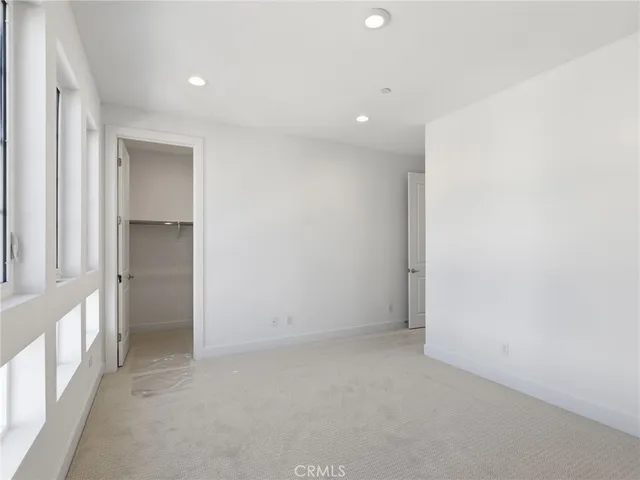 a bathroom with a granite countertop sink a toilet and a mirror
