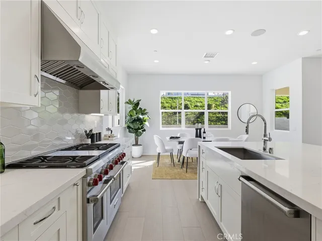 a kitchen that has a sink and a stove