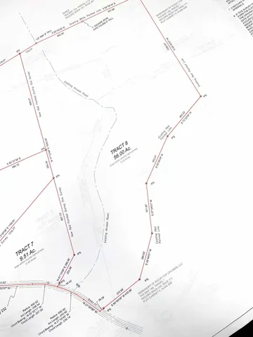 a picture of a room with a white wall and a large window