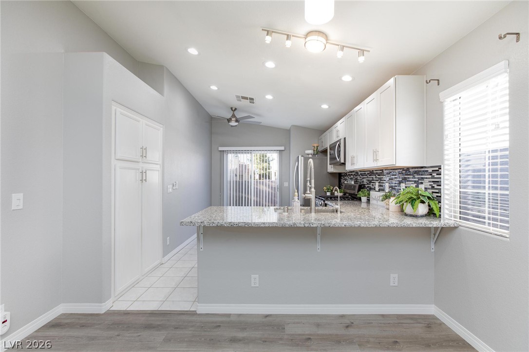 2254 Ramsgate Drive Henderson, NV 89074 - Photo 6 of 43 A sleek, contemporary kitchen with generous counter space, perfect for culinary endeavors and casual dining.
