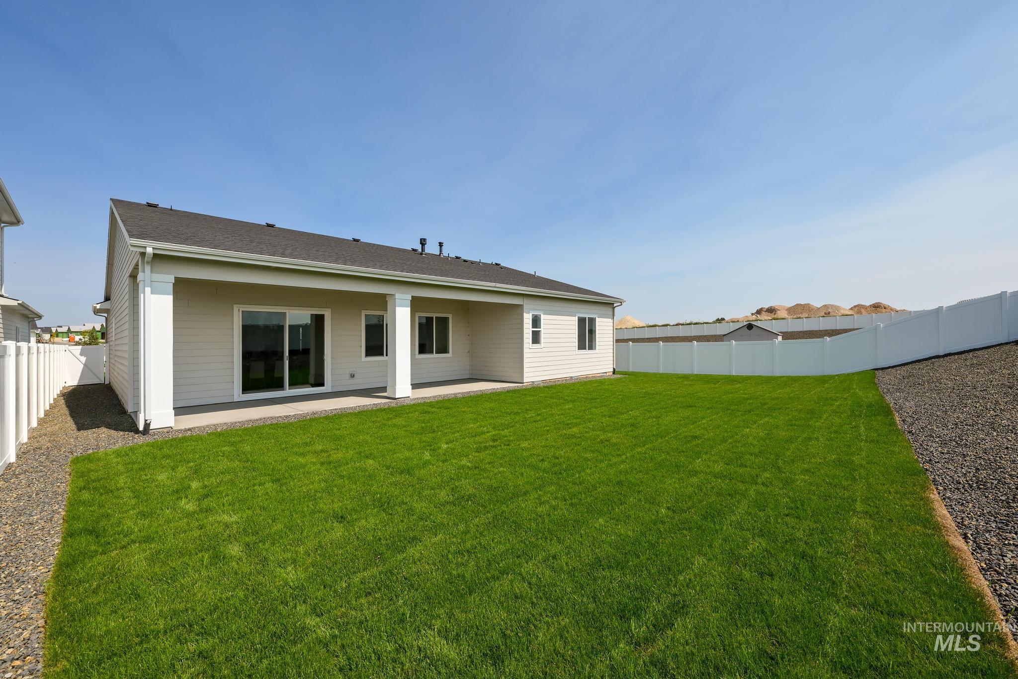 1195 West Switchgrass Drive Meridian, ID 83642 - Photo 10 of 11 Back of house featuring a fenced backyard, a patio, and a shingled roof