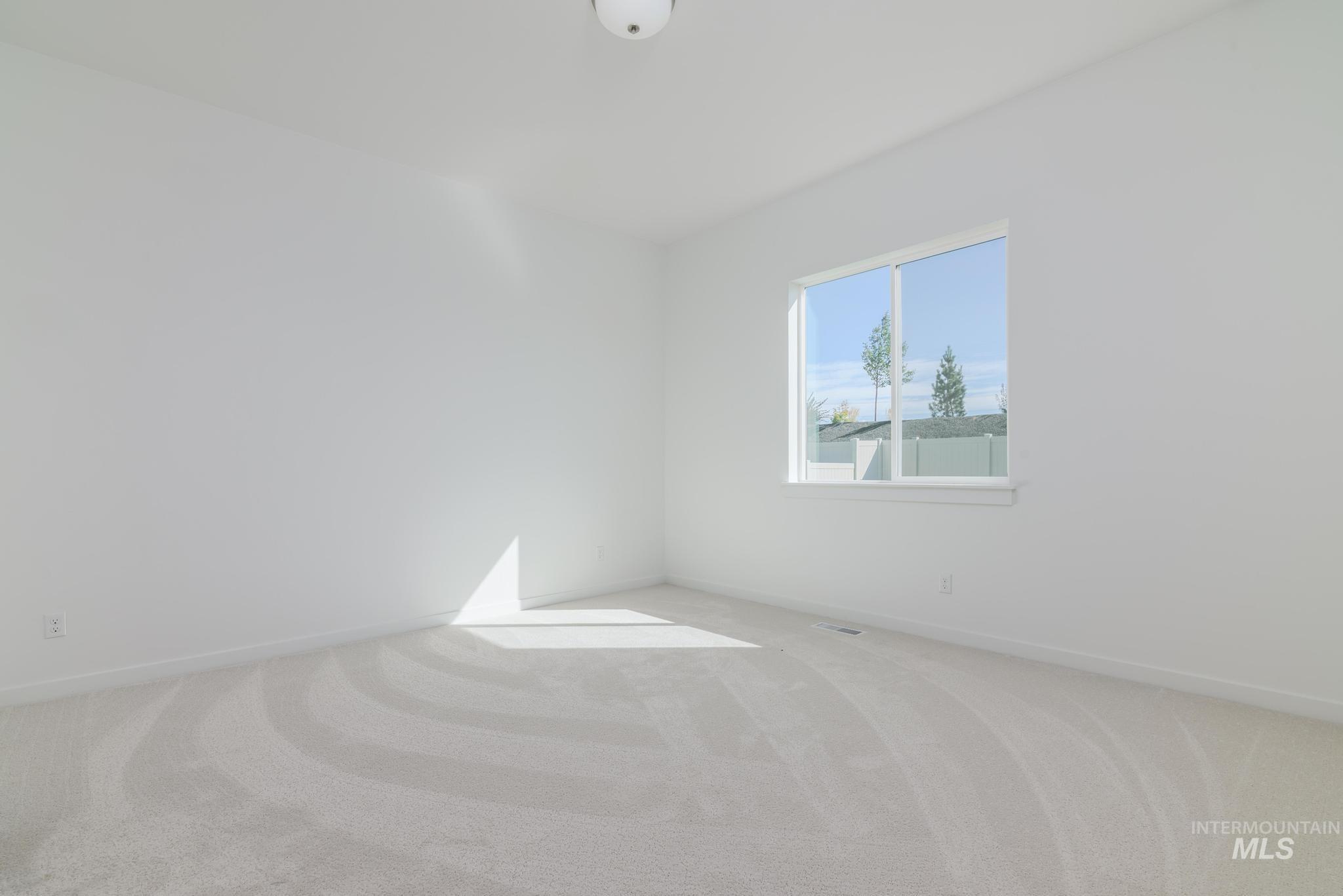 1195 West Switchgrass Drive Meridian, ID 83642 - Photo 6 of 11 Carpeted spare room featuring baseboards