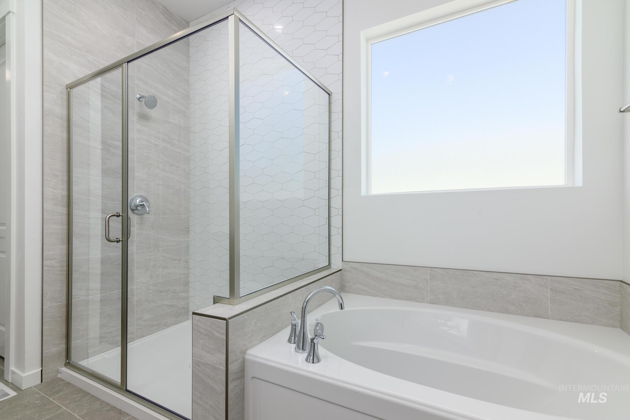 1195 West Switchgrass Drive Meridian, ID 83642 - Photo 7 of 11 Bathroom featuring a bath and a stall shower