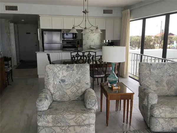 a dining room with furniture wooden floor and a chandelier