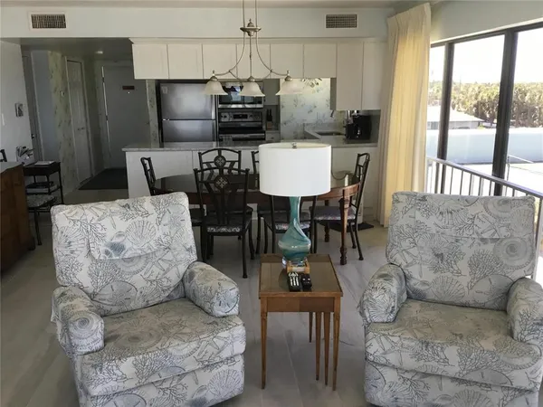 a living room with fireplace furniture and a large window